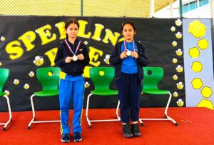The image is of a young girl holding a trophy. She is smiling and looks proud.